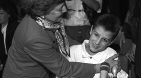 Ryan White gets a hug from Dr. Cory SerVaas after testifying to a presidential commission on AIDS in 1988. He told the panel of his battle with the disease and the taunts and jeers he endured from classmates.