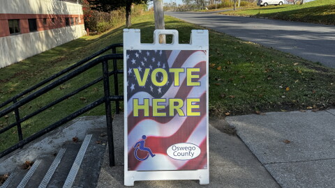 A directional Vote Here sign positioned outside a polling location in Central New York.