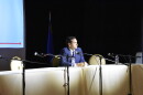 Cisco Aguilar sits at a long table with microphones by himself. 