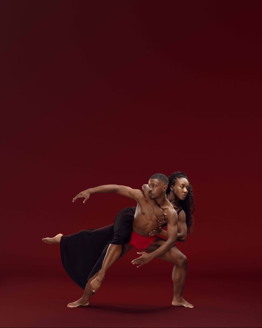 Ailey II's Adanna Smalls and Vic E. Davis posing in front of maroon background