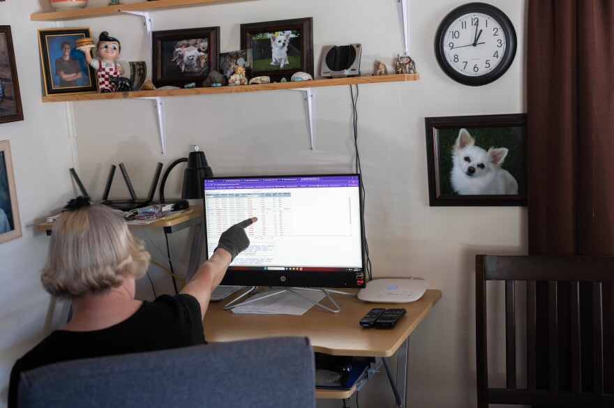 Teresa Blazer looks at Oregon Health Authority information about her home's water system in Shady Cove in May of 2024.