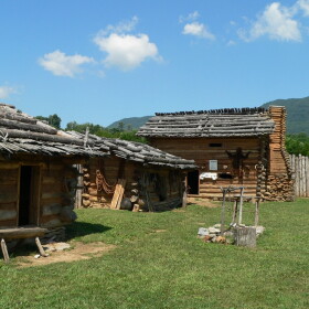 Inside the reconstructed Martin's Station fort at Wilderness Road State Park in Virginia. Martin’s Station was near Ruddell’s Station and was attacked and breached two days later. George Lail and many others were taken from Ruddell’s Station. Cmadler, Own Work under: https://en.wikipedia.org/wiki/GNU_Free_Documentation_License.