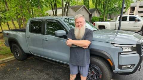 Dale Hart proudly stands in front of his 2025 Nissan Frontier. He says he's been surprised at the positive comments and compliments he has gotten about his ride.