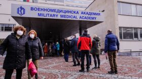 People wait in front of the hospital of the Military Medical Academy in Sofia, Bulgaria, on Feb. 21 for a COVID-19 vaccination.