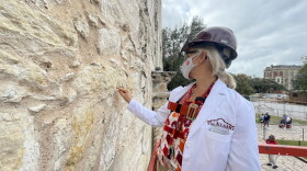 Conservator Pam Rosser extracts tiny pigment fragments from the Alamo for examination.