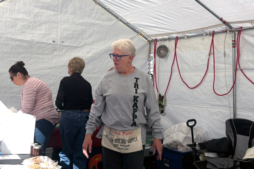 Tri Kappa member Jane Bennett helps customers at the group’s Apple Festival table.
