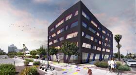 Black five story building with multicolored tiles on the ground