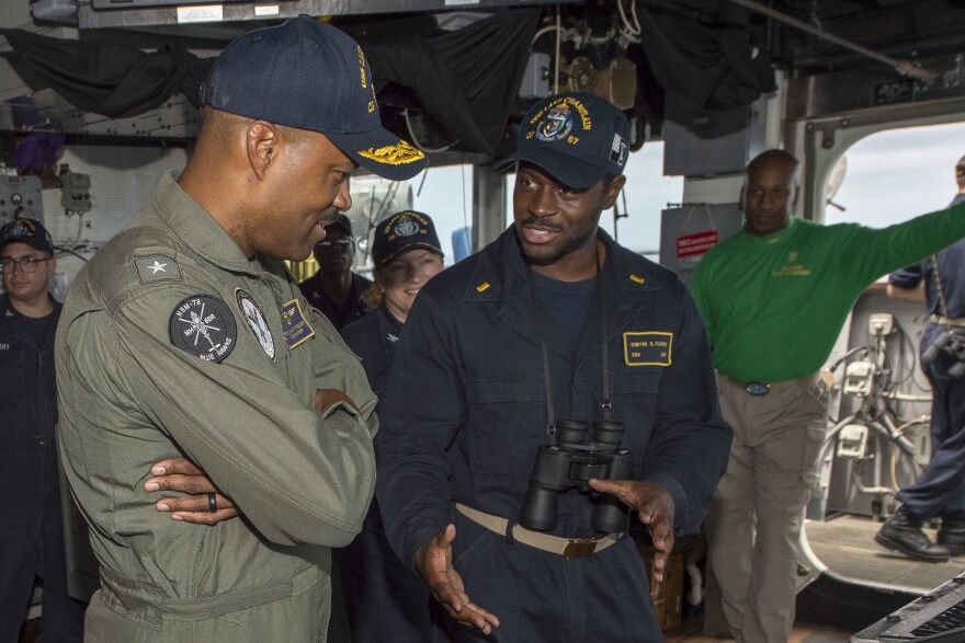 Rear Adm. Alvin Holsey (left) speaks with Ensign Dimitri Foster aboard the USS Lake Champlain in 2018. Holsey - one of the Navy's few Black admirals - heads the One Navy Task Force