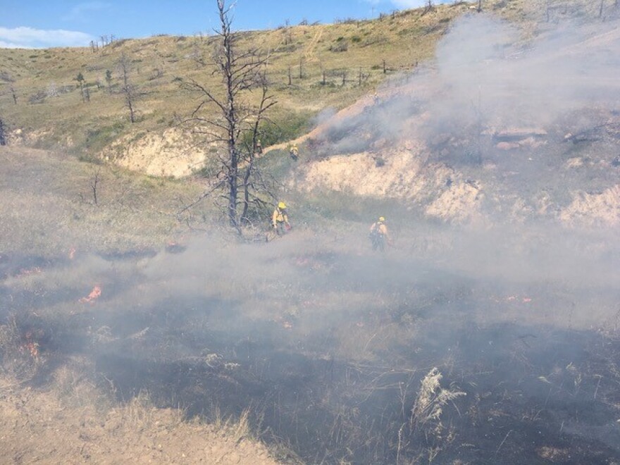 Fire fighers use drip torches to contain a grass fire ignited by a burning coal seam on the Northern Cheyenne Reservation over Labor Day weekend.