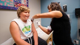 FILE: Charlie Cardus of South Portland, 11, receives A TDaP booster, which includes the pertussis vaccine, from nurse Vanessa Kearns at South Portland Pediatrics in Maine on September 14, 2017.