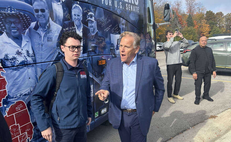 Former congressman and Republican candidate for Michigan's U.S. Senate seat Mike Rogers walks off his campaign bus before attending an event hosted by the Northern Michigan Chamber Alliance on Friday, Oct. 23, 2026.