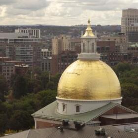 The Massachusetts State House's golden dome pictured against Boston.
