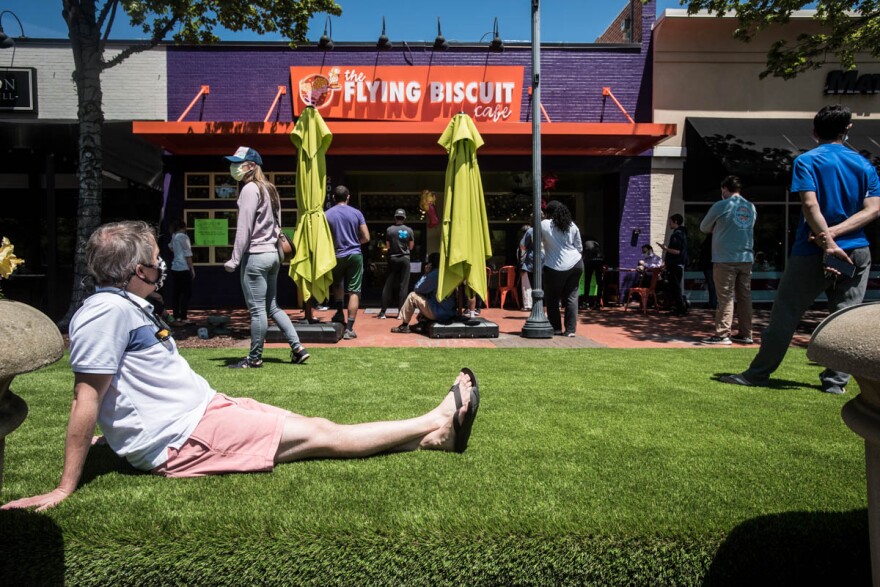 File photo of Dan Meyer, left, of Raleigh, NC, waiting to pick up a Mother's Day brunch at Flying Biscuit in Raleigh's Cameron Village. 