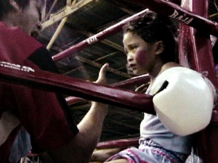 Stam Sor Con Lek fights to support her family. Her winnings go toward completing their half-finished house.