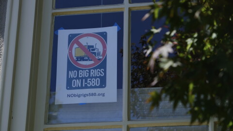 A “NO BIG RIGS ON I-580” poster hangs in the front window of Susan Gallardo’s home in Oakland’s Crocker Highlands neighborhood.