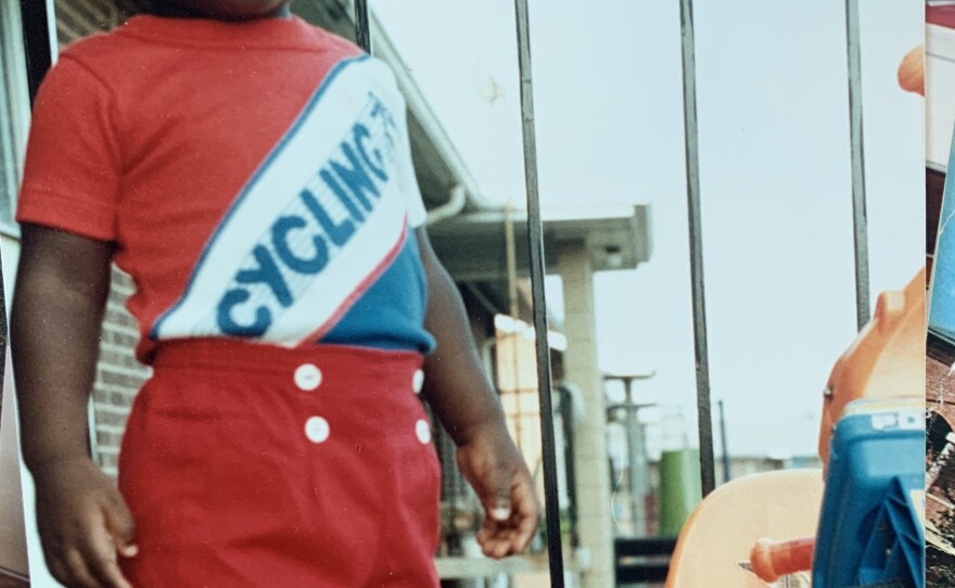 Ndelo as a toddler on a porch.