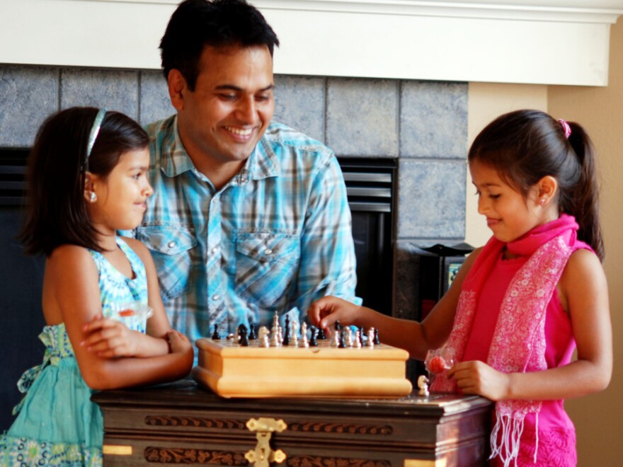 Naresh Dhiman plays chess with his two daughters. Dhiman's wife encouraged him to launch his own company, and she now works 3 to 4 hours a day overseeing their software developers in India.