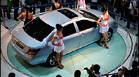 Visitors view an F3DM electric vehicle at the 2008 China High-Tech Fair on Oct. 14, 2008, in Shenzhen.
