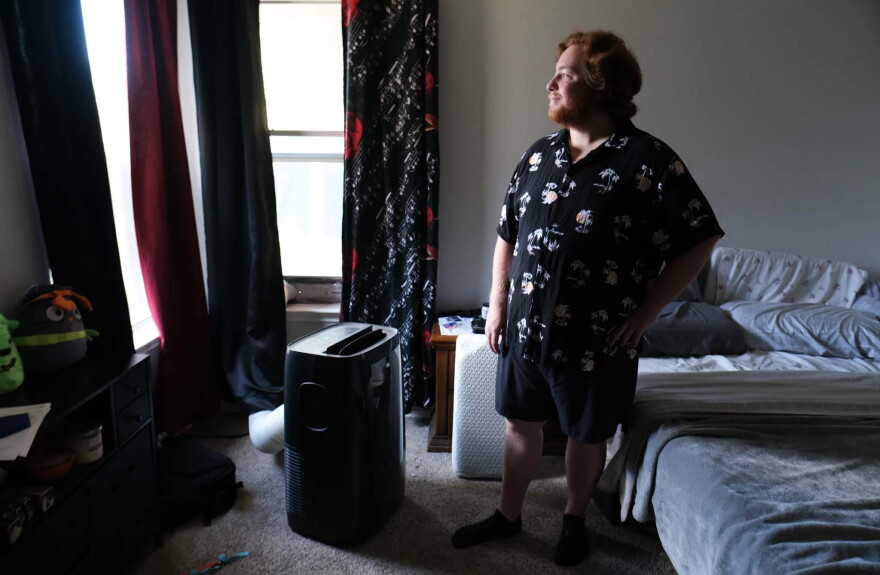 Alek Micklethwait stands in front of a portable air conditioning unit on Aug. 10, 2026, at his home in Hutto.