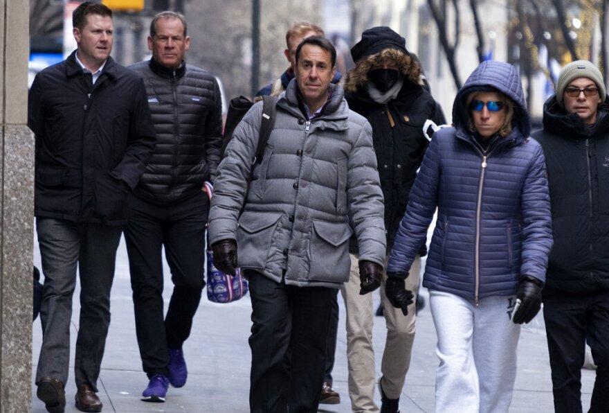 Major League Baseball deputy commissioner Dan Halem, center, arrives for a meeting in New York, Monday, Jan. 24, 2022, for the first in-person baseball negotiating session since the MLB lockout began. At far left is Patrick Houlihan, Senior Vice President & Deputy General Counsel, Labor Relations at Major League Baseball, and second from left is Colorado Rockies owner Dick Montfort.