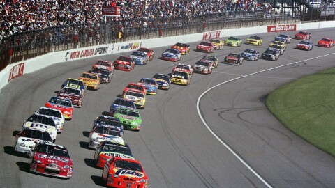 Ricky Rudd, front right, and Jeff Burton, front left, lead the field as they take the green flag to start the NASCAR Cup Series auto race at North Carolina Motor Speedway near Rockingham, N.C., Feb. 21, 1999. 