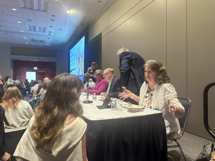 New Mexico Sen. Linda Trujillo (D-Santa Fe), right, speaks with attendees at the National Conference of State Legislatures in Chicago after presenting on national issues surrounding childcare. (Kevin Hardy/Stateline)