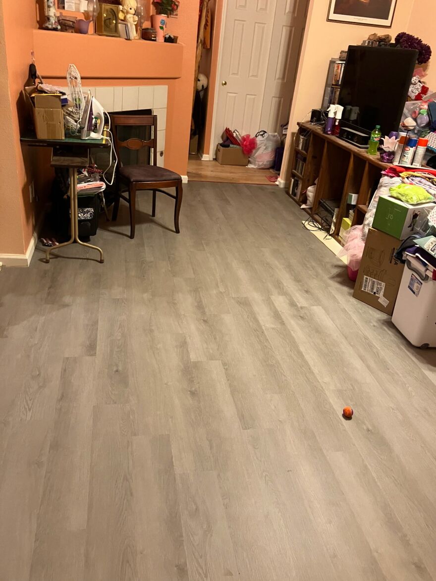 A living room with grey flooring.