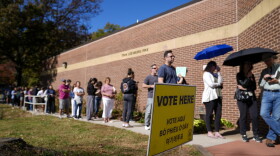 People wait in line before the polling place at Tysons-Pimmit Regional Library in Falls Church, Va. opens, Thursday, Oct. 31, 2024.