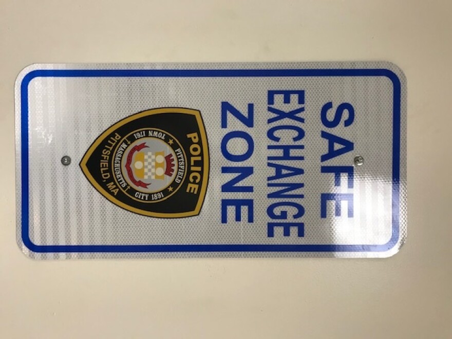 A sign reads "Safe Exchange Zone" over the Pittsfield Police Department logo.