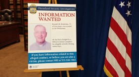 A wanted poster for the Rev. Kenneth Bernard Hendricks sits on display at the U.S. Attorney's office.