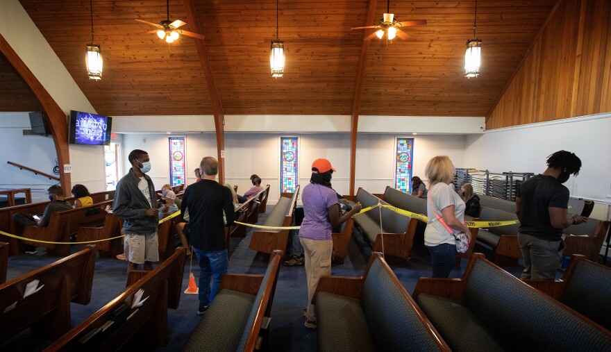 Patients form a line in the church sanctuary.