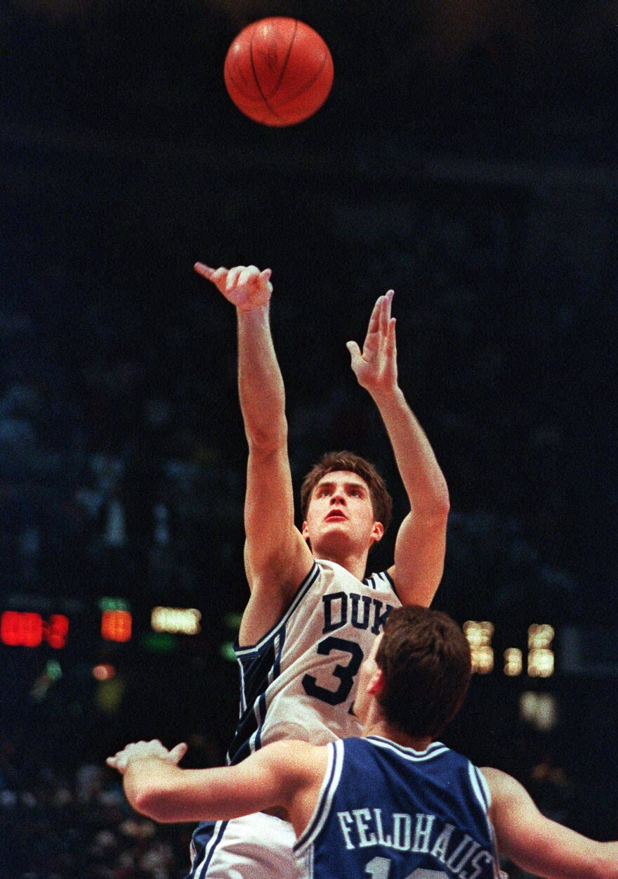 In this March 28, 1992, file photo, Duke's Christian Laettner takes the winning shot in overtime over Kentucky's Deron Feldhaus.