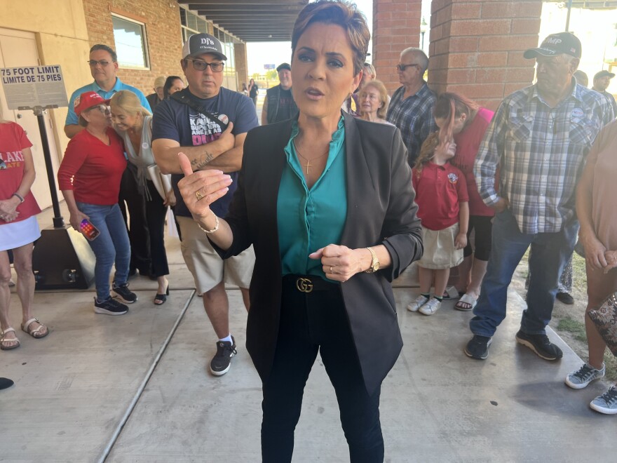 Kari Lake speaks to reporters surrounded by supporters in downtown Yuma on Tuesday, Oct. 22, 2024.