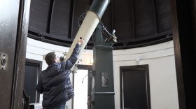 Visiting lecturer Vaclav Pavlik adjusts the Kirkwood Observatory telescope for viewing.