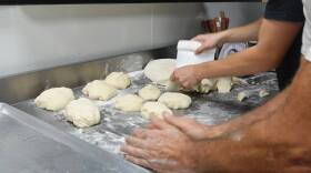 Dueño y miembro del personal midiendo y haciendo la pizza. Foto por: Valentina Echeverri.