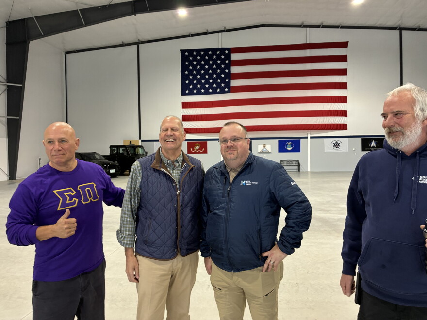 John Sununu (second from left), the Republican nominee in this year's U.S. Senate race, meets with employees at Keene Dillant-Hopkins Airport in Swanzey, Friday, Oct. 16, 2026.