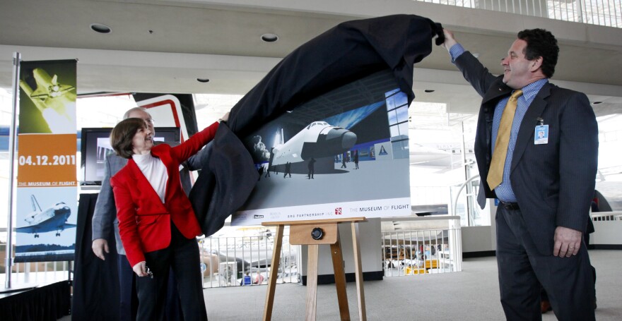 Retired astronaut Bonnie Dunbar, left, and Museum of Flight board chairman Kevin Callaghan unveil in Seattle a rendering of a full-fuselage shuttle trainer that the museum will receive.