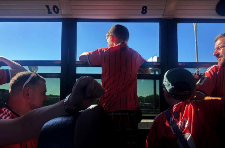 A young fan of Scotland looks out of the window on a chartered school bus headed for Gillette Stadium.