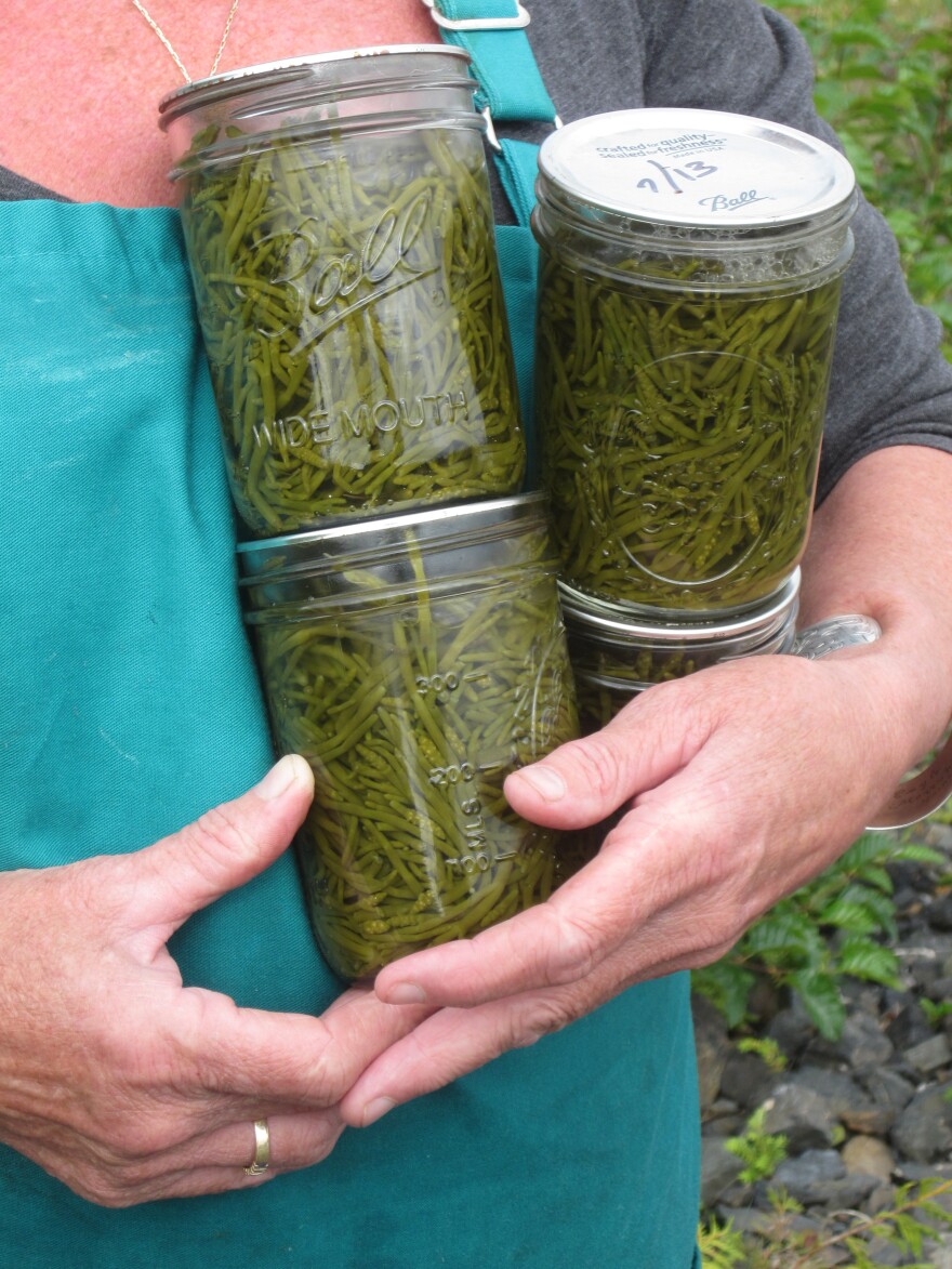 Mary Anna Murphy, one of only two year-round residents on Wadleigh Island, holds jars of sea asparagus she canned.<strong></strong>