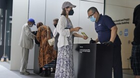 Staff at the Modern Museum of Art check visitors' proof of vaccination in New York on Sept. 13, 2021.