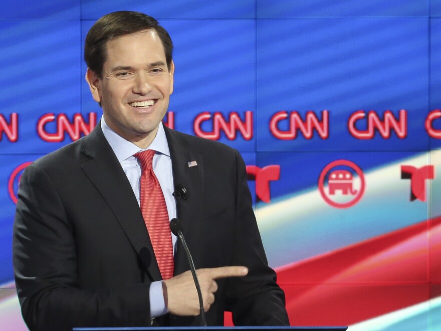 Florida Sen. Marco Rubio mockingly smiles and points toward Donald Trump during the last Republican presidential debate before Super Tuesday. Rubio hopes to pick off some states.