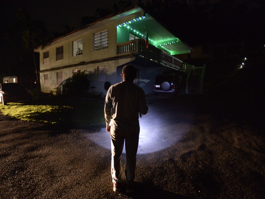 Jose Luis Gonzalez of Morovis illuminates his path with a lantern on a street of the Barrio Patrón.