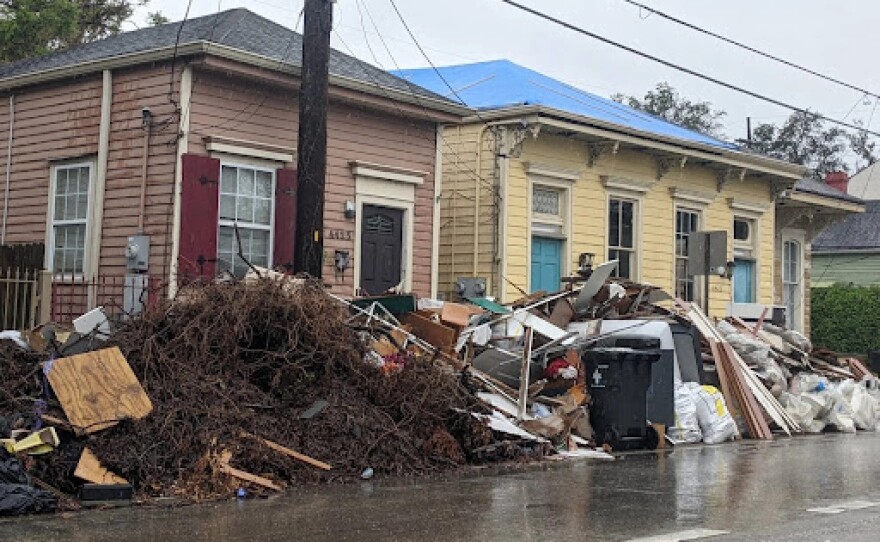 Trash, vegetal debris and storm damage waits to be picked up on Tchoupitoulas Street, on Tuesday, Sept. 14, 2021.