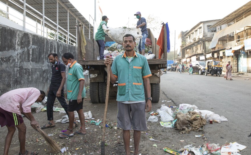 Sanitation worker Ramesh Solanki cleans the streets outside Palghar railway station. "I get up every morning at 5:30, and I see news about the vaccines on TV," he says. "I don't know about any controversies. I just know I'm proud to be part of this." As a sanitation worker, he's among the first Indians eligible to get the coronavirus vaccine.