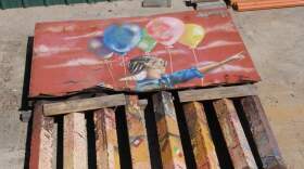 A portion of the border wall is shown on March 18, 2024. Some artists used metal panels meant to prevent people from climbing the border as flat a canvas. (Carlos Castilo/KPBS)