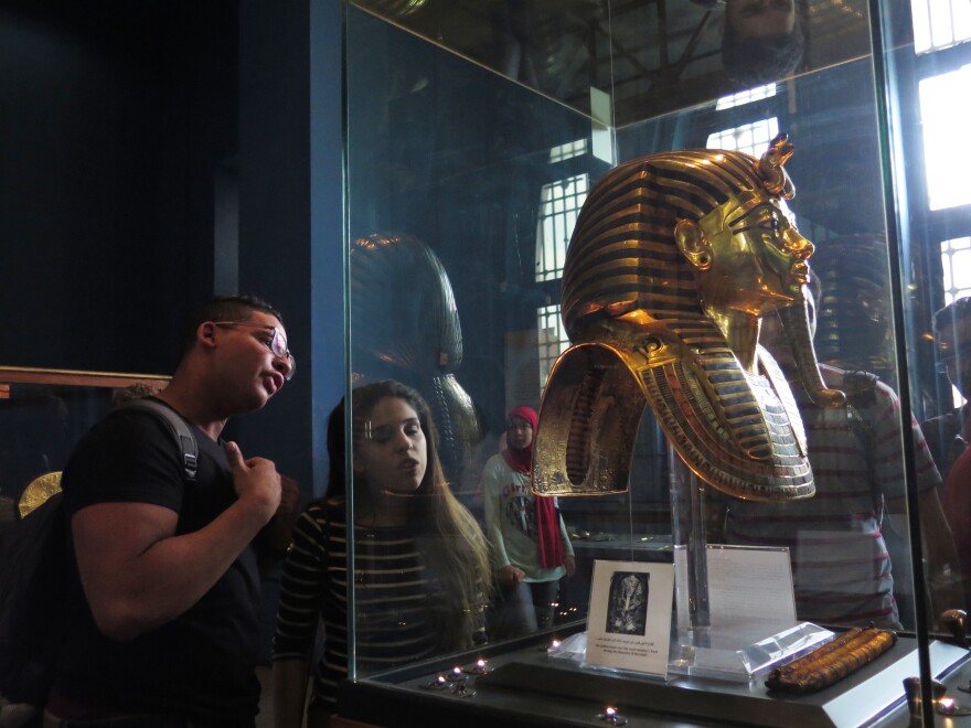 Museum visitors view King Tutankhamen's golden mask at the Egyptian Museum in central Cairo. The mask and thousands of other artifacts from Tut's tomb will be moved to the new Grand Egyptian Museum.