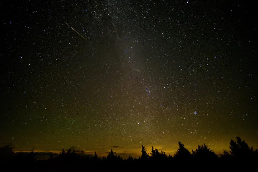 In this 30-second exposure, a meteor streaks across the sky during the annual Perseid meteor shower Friday, Aug. 12, 2016 in Spruce Knob, W. Va.