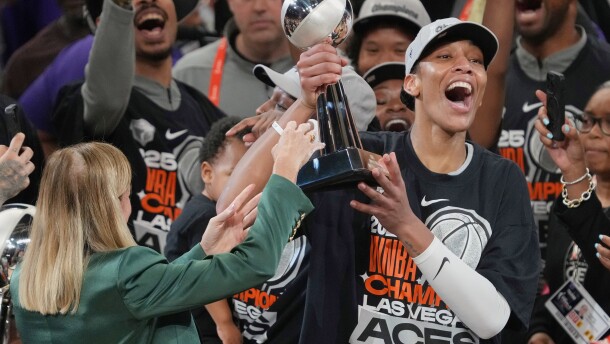 FILE - Las Vegas Aces center A'ja Wilson, center right, holds up her MVP trophy after Game 4 of the WNBA basketball finals against the Phoenix Mercury, Friday, Oct. 10, 2025, in Phoenix. (AP Photo/Rick Scuteri, File)