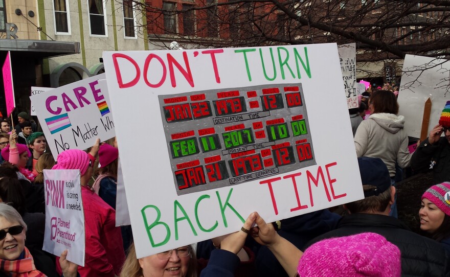 Supporters hold signs at rally