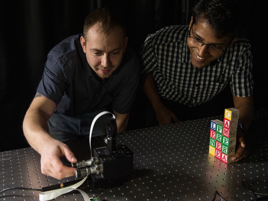 Rice University graduate students Jesse Adams and Vivek Boominathan set up a test shot with a FlatCam prototype.